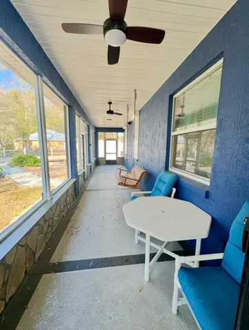 a living room with furniture windows and a flat screen tv