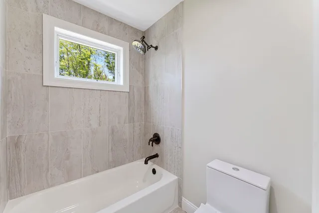 a bathroom with a bathtub and a toilet