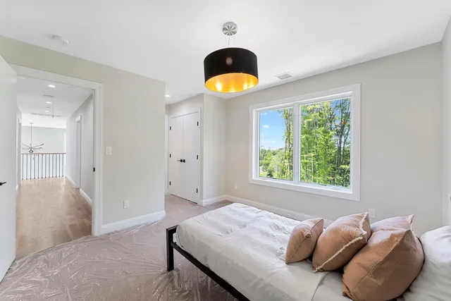 a bedroom with a bed and a large window