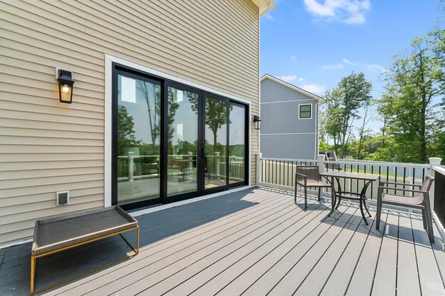 a balcony with furniture and wooden floor