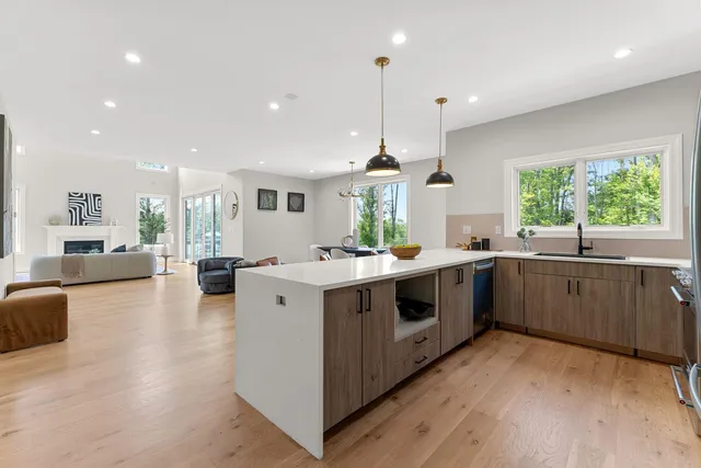 a kitchen with a stove cabinets and wooden floor