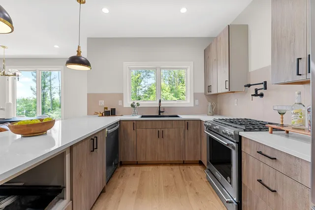 a kitchen with a sink stove and window