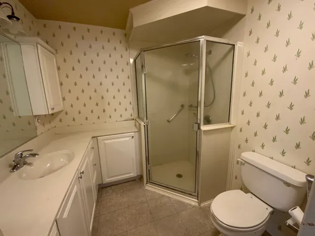 a bathroom with a sink toilet and shower