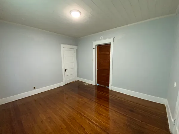an empty room with wooden floor