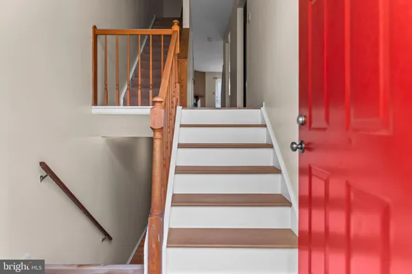 a view of staircase with white walls and a window