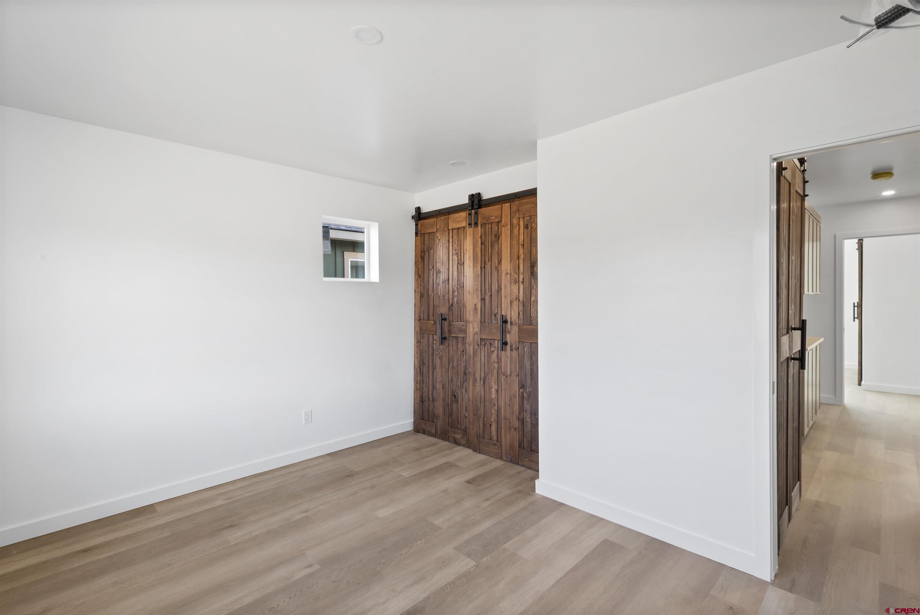 228 Redcliff Drive Ridgway, CO 81432 - Photo 11 of 35 an empty room with wooden floor and a window