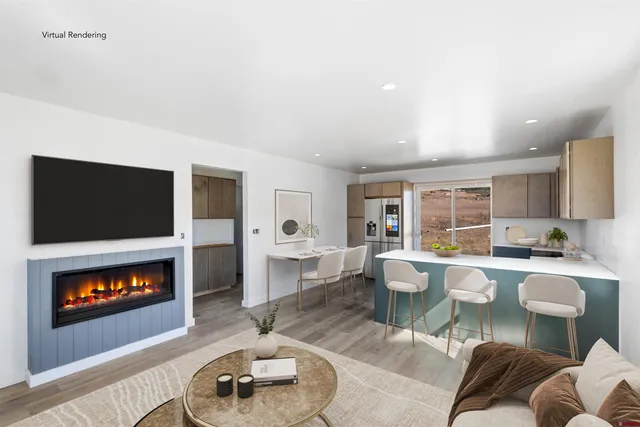 a living room with furniture a flat screen tv and a fireplace