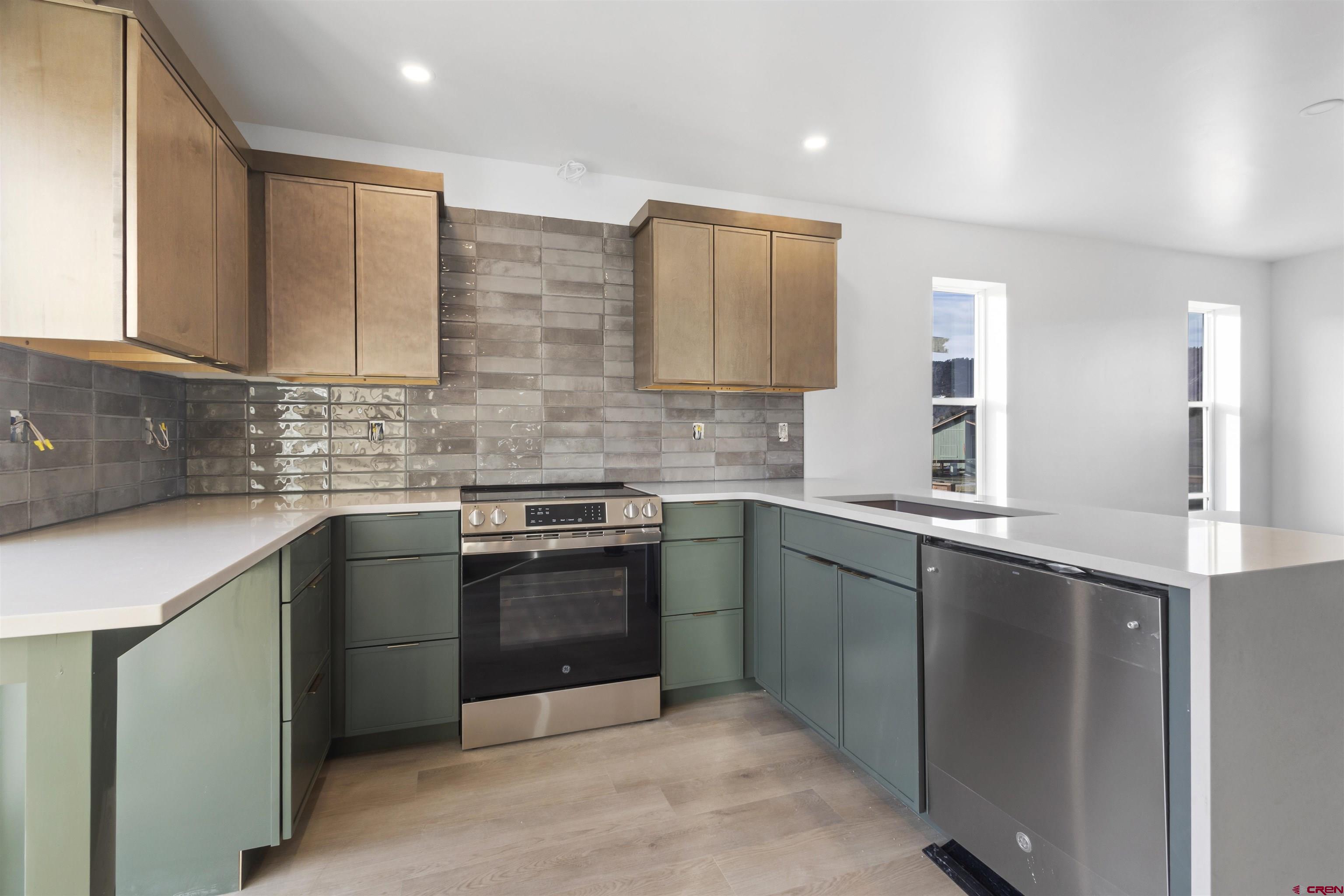 228 Redcliff Drive Ridgway, CO 81432 - Photo 6 of 35 a kitchen with stainless steel appliances granite countertop a sink stove and refrigerator