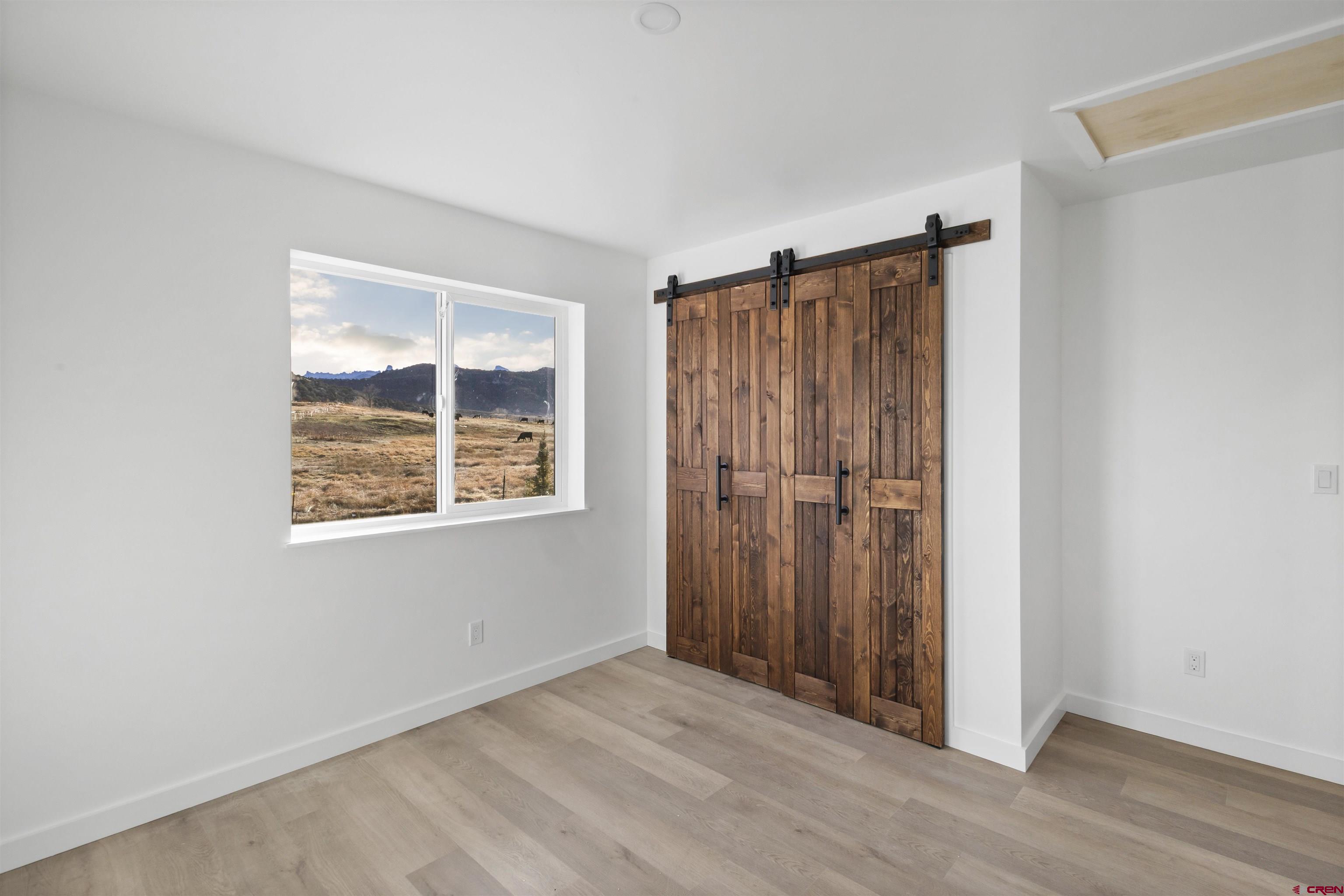 228 Redcliff Drive Ridgway, CO 81432 - Photo 10 of 35 an empty room with windows