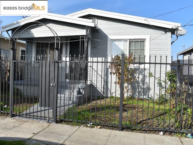 1285 77th Avenue Oakland, CA 94621 - Photo 1 of 8 a front view of a house with a garden