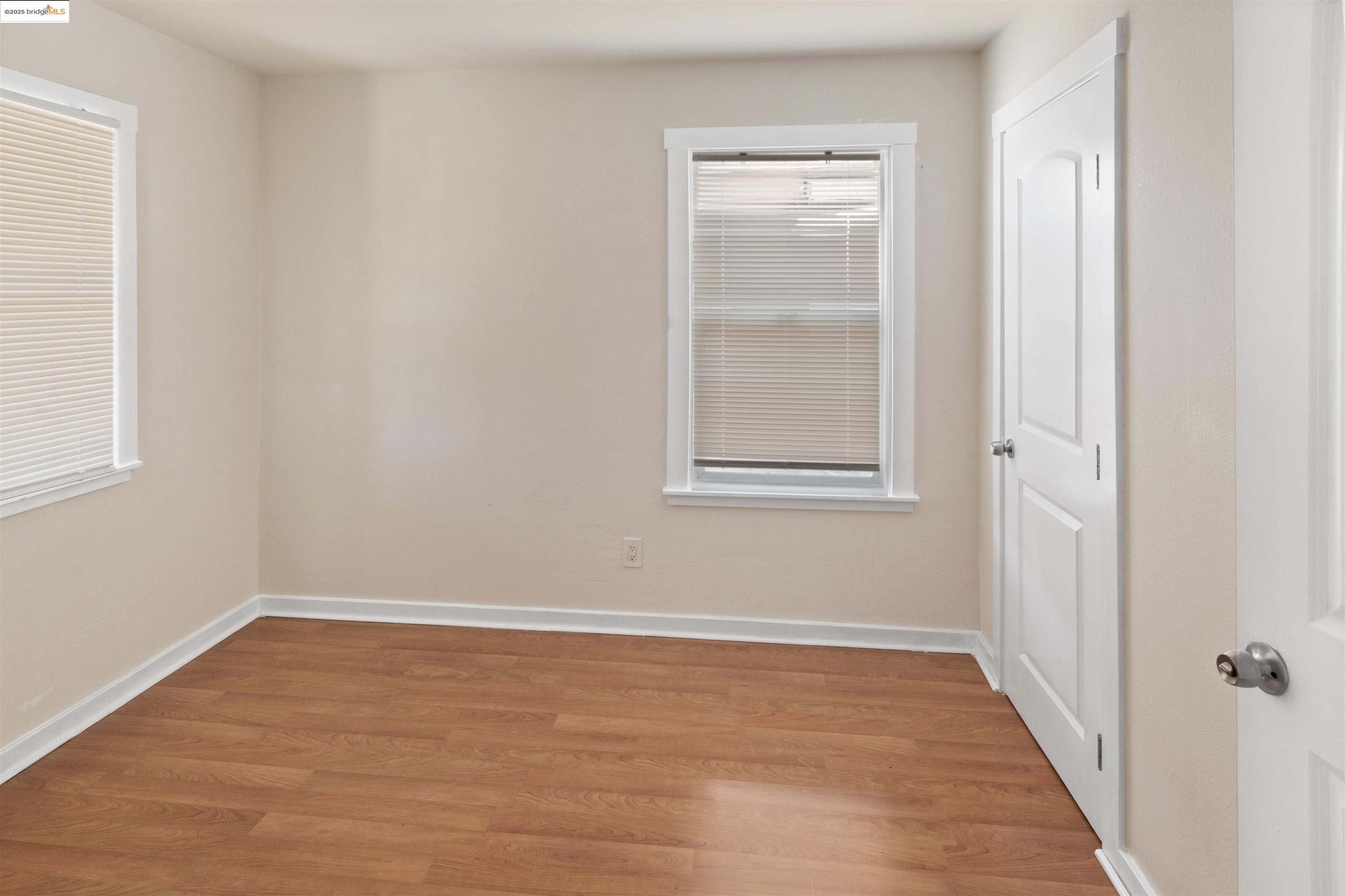 1285 77th Avenue Oakland, CA 94621 - Photo 8 of 8 wooden floor in an empty room