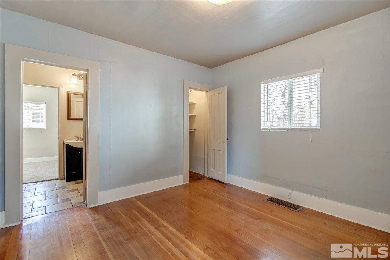 735 Plumas Street Reno, NV 89509 - Photo 12 of 25 an empty room with wooden floor and windows