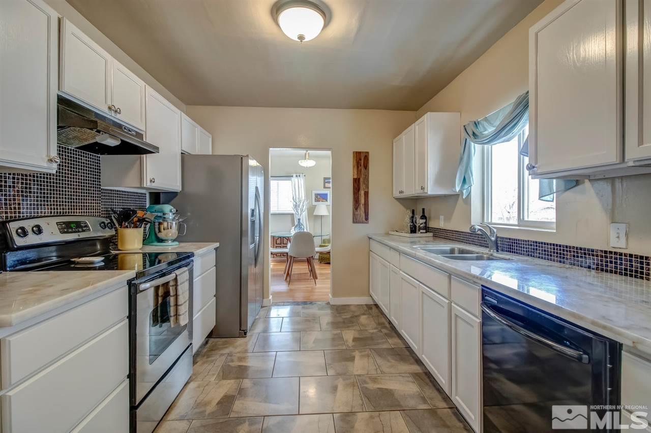 735 Plumas Street Reno, NV 89509 - Photo 14 of 25 a kitchen with stainless steel appliances granite countertop a sink a stove and a refrigerator