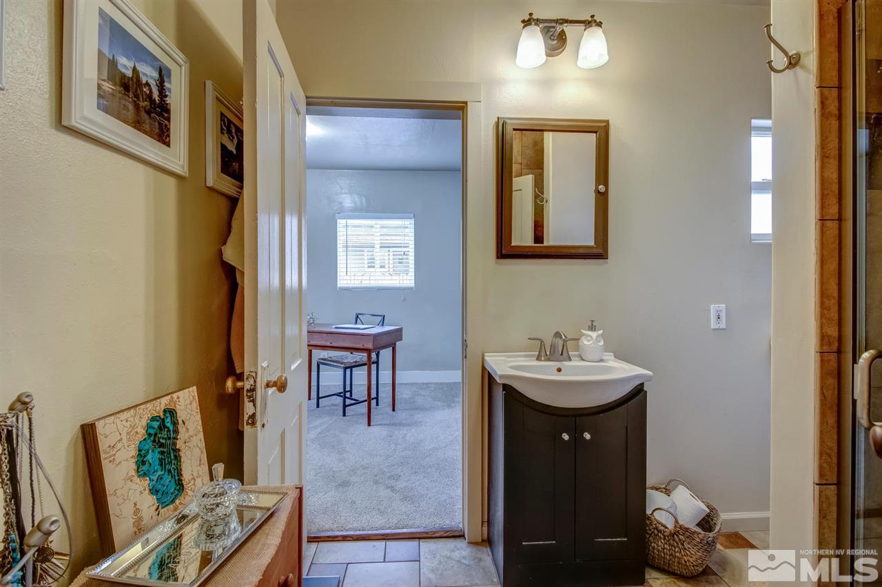 735 Plumas Street Reno, NV 89509 - Photo 17 of 25 a bathroom with a sink a mirror and a toilet
