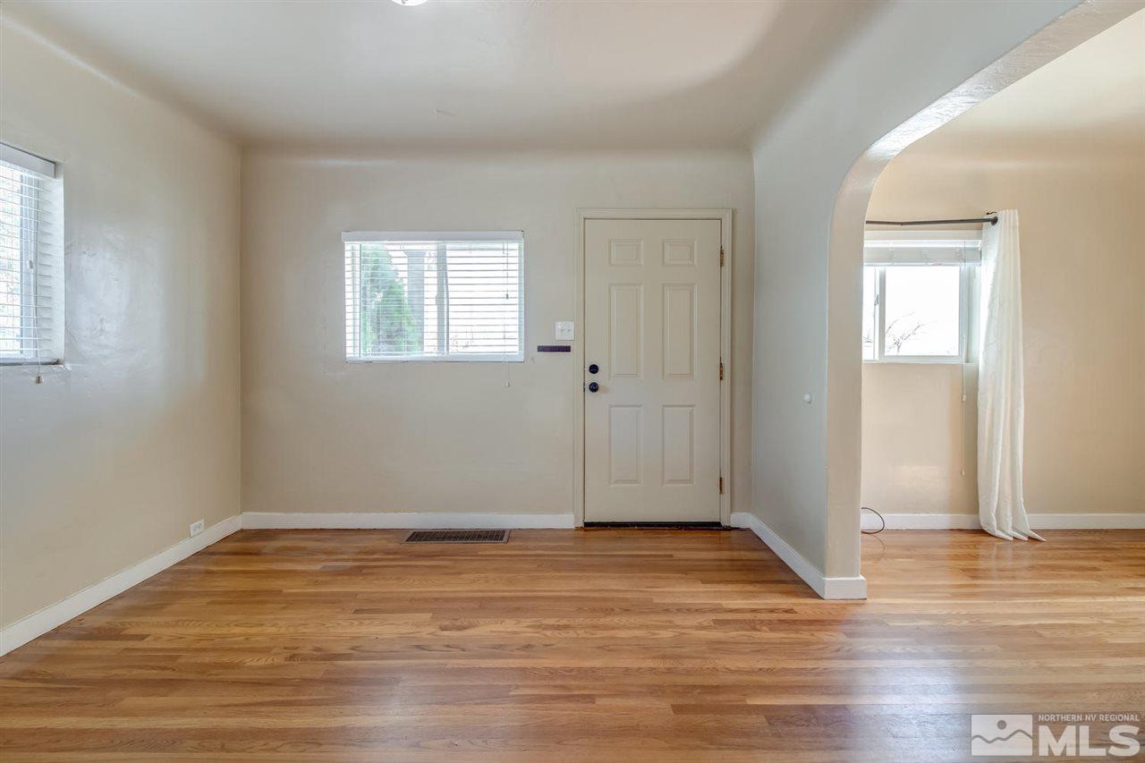 735 Plumas Street Reno, NV 89509 - Photo 3 of 25 an empty room with wooden floor and windows