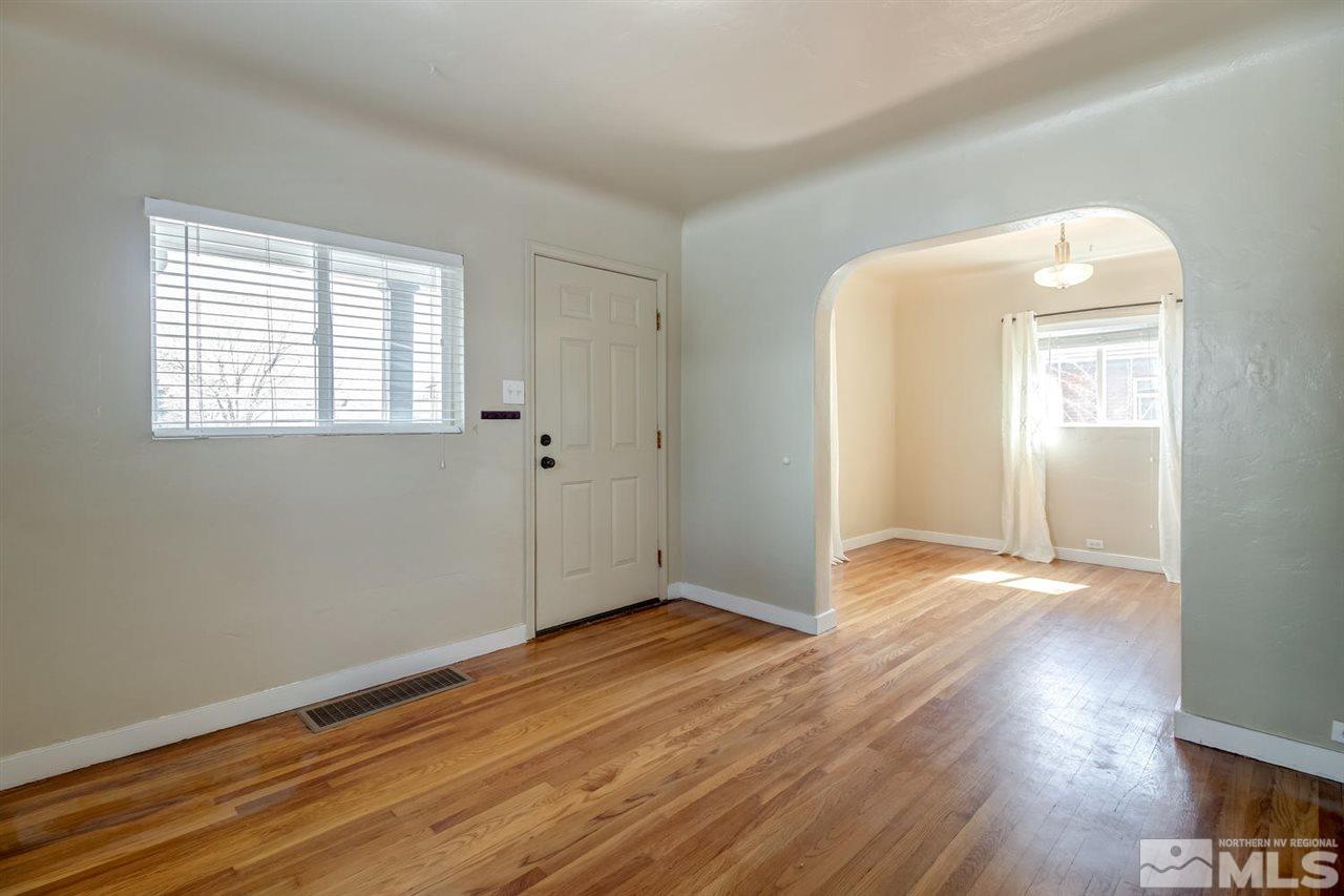735 Plumas Street Reno, NV 89509 - Photo 4 of 25 an empty room with wooden floor and windows