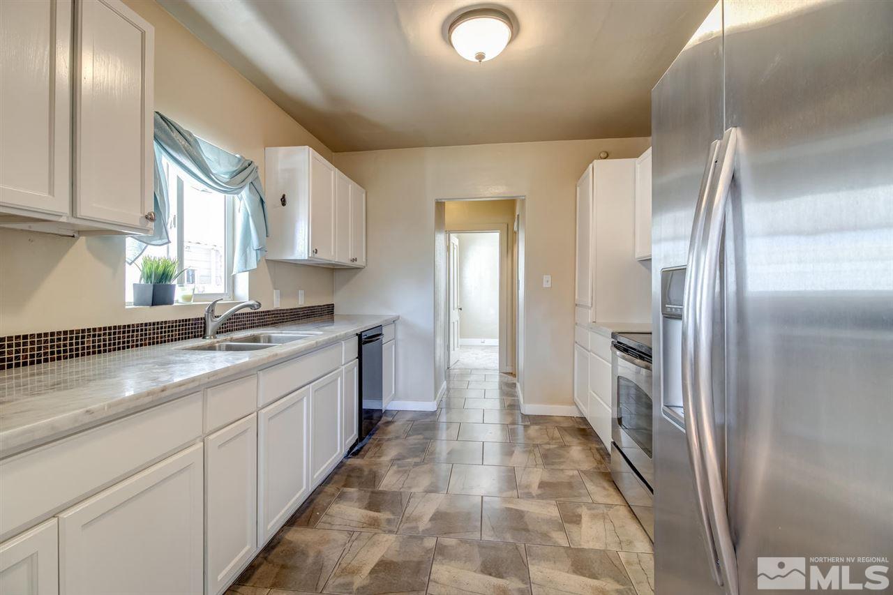 735 Plumas Street Reno, NV 89509 - Photo 10 of 25 a kitchen with stainless steel appliances granite countertop a refrigerator and a sink
