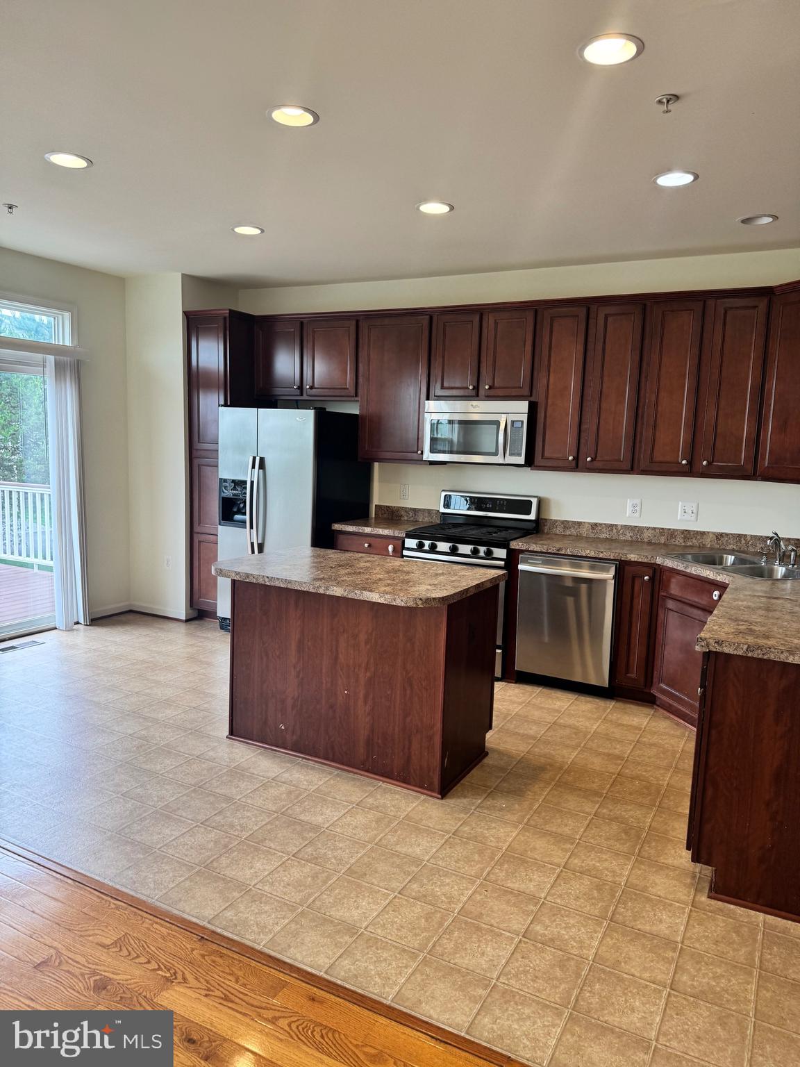 1608 Poplar Run Drive Silver Spring, MD 20906 - Photo 13 of 18 a kitchen with stainless steel appliances granite countertop a stove a sink dishwasher a refrigerator and a oven with wooden floor