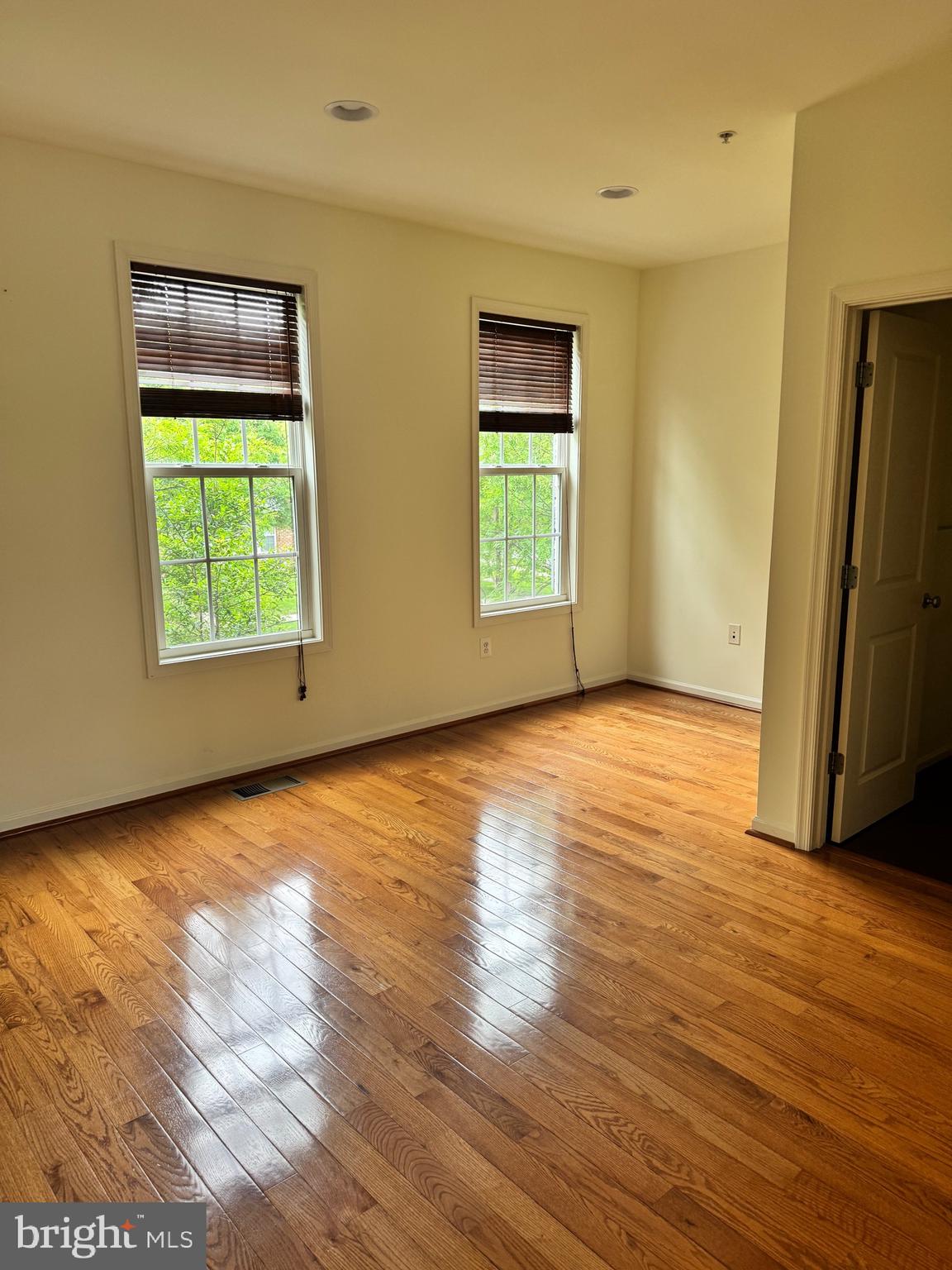 1608 Poplar Run Drive Silver Spring, MD 20906 - Photo 14 of 18 an empty room with wooden floor and windows
