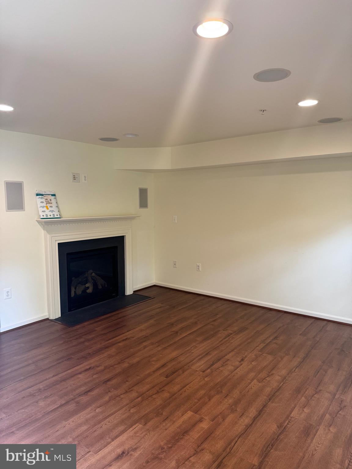 1608 Poplar Run Drive Silver Spring, MD 20906 - Photo 2 of 18 a view of an empty room with wooden floor fireplace and a window