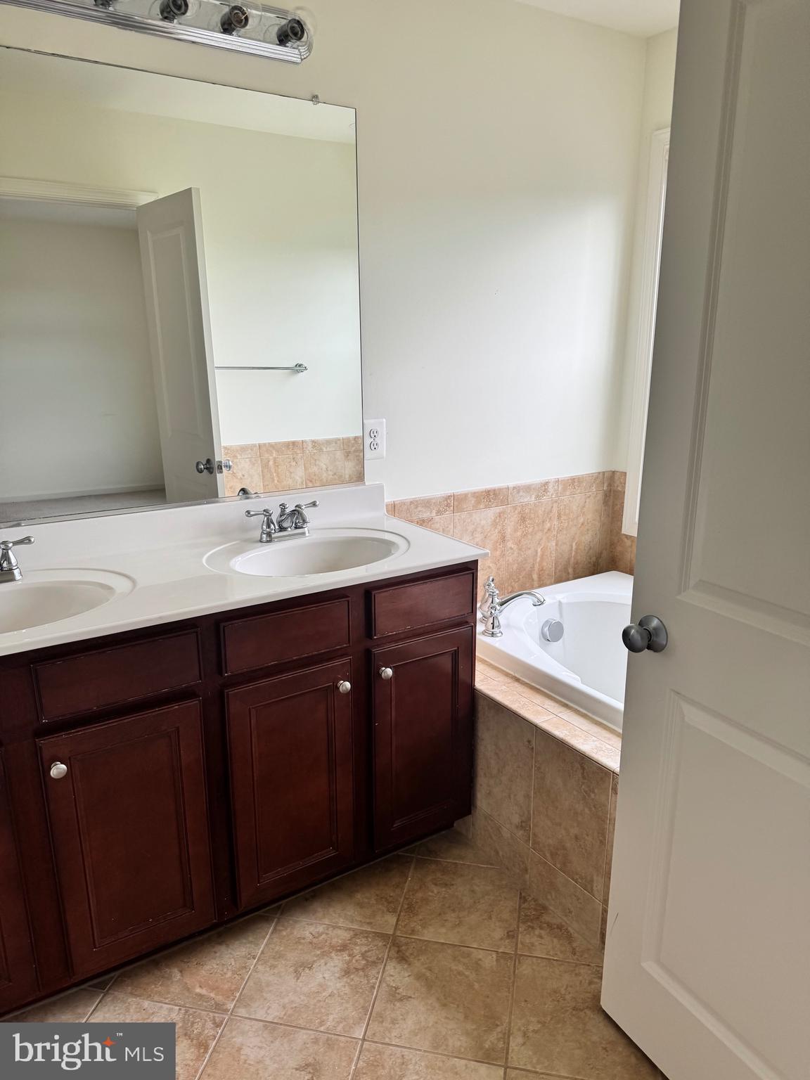 1608 Poplar Run Drive Silver Spring, MD 20906 - Photo 7 of 18 a bathroom with a tub sink and mirror