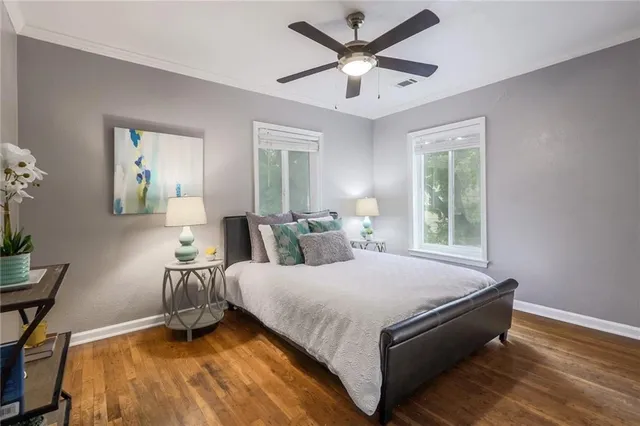 a spacious bedroom with a bed and a window