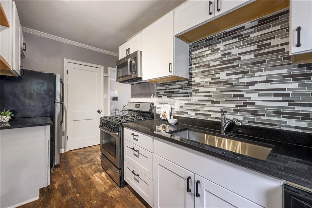 1507 Pease Road, Unit 7 Austin, TX 78703 - Photo 4 of 11 a kitchen with stainless steel appliances a sink stove and refrigerator