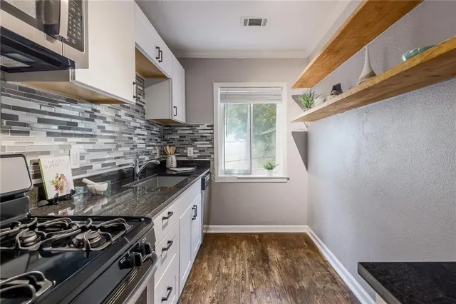 a kitchen with a stove and a sink