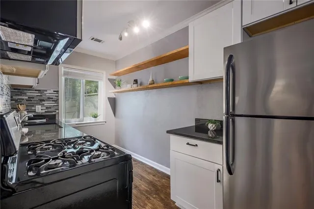 a kitchen with stainless steel appliances a refrigerator and a stove