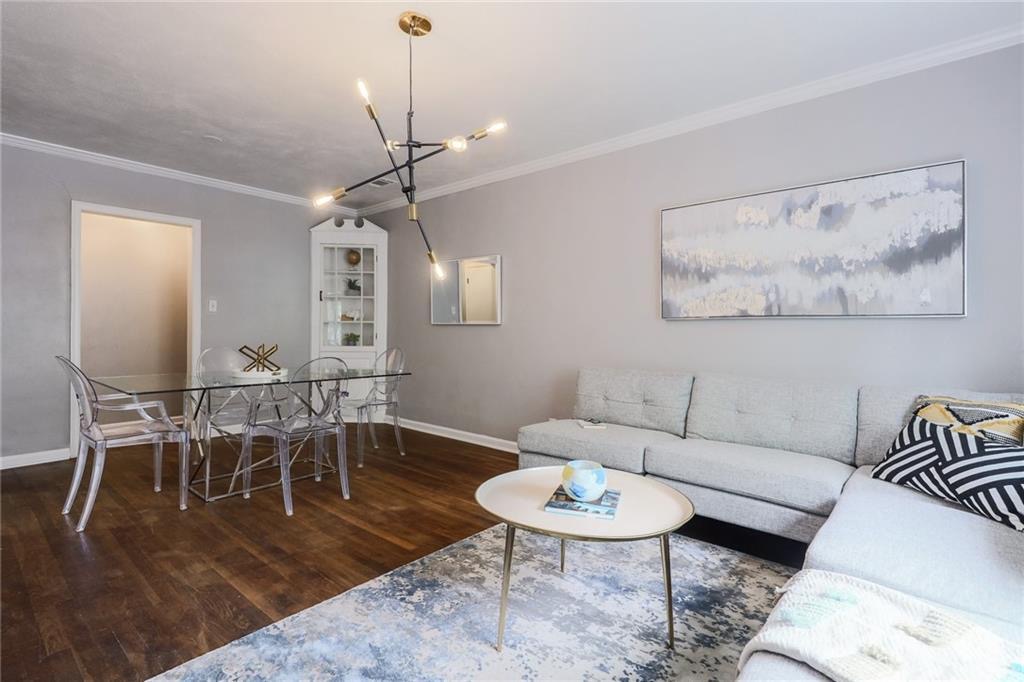1507 Pease Road, Unit 7 Austin, TX 78703 - Photo 10 of 11 a living room with furniture a dining table and a chandelier