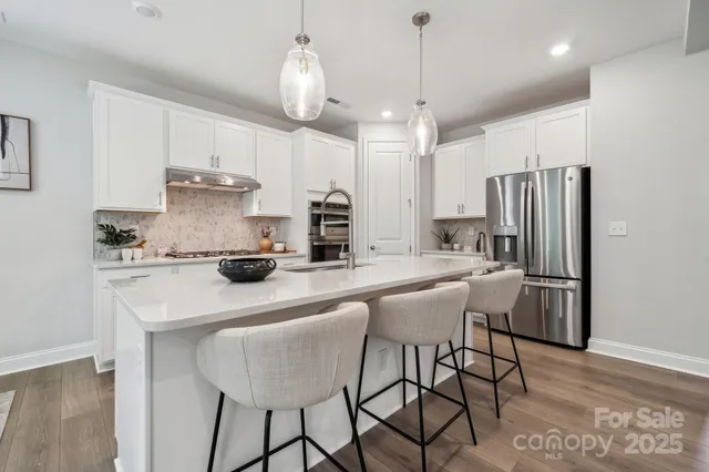 a kitchen with stainless steel appliances a sink stove and cabinets