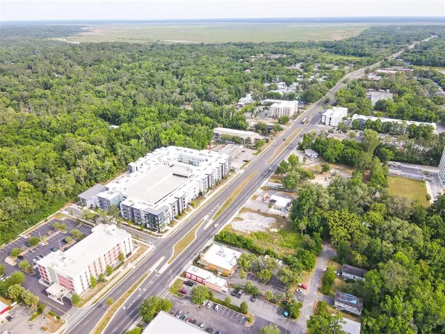 an aerial view of residential houses with yard
