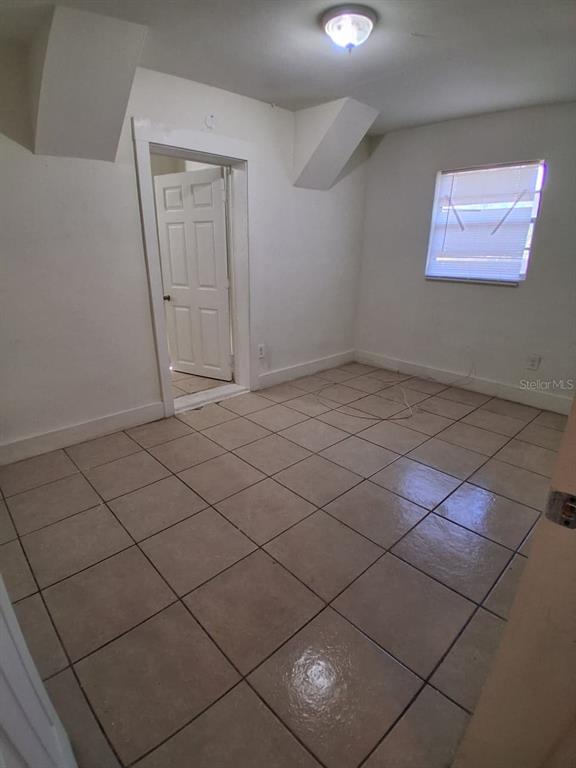 4115 Columbia Street Orlando, FL 32811 - Photo 16 of 16 an empty room with a wooden floor and windows