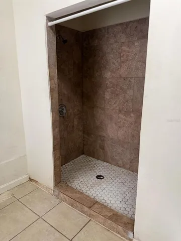 a bathroom with a glass shower door