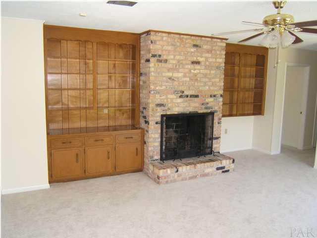 1195 Commonwealth Road Pensacola, FL 32504 - Photo 8 of 16 Family room with built in bookshelves and real fireplace.