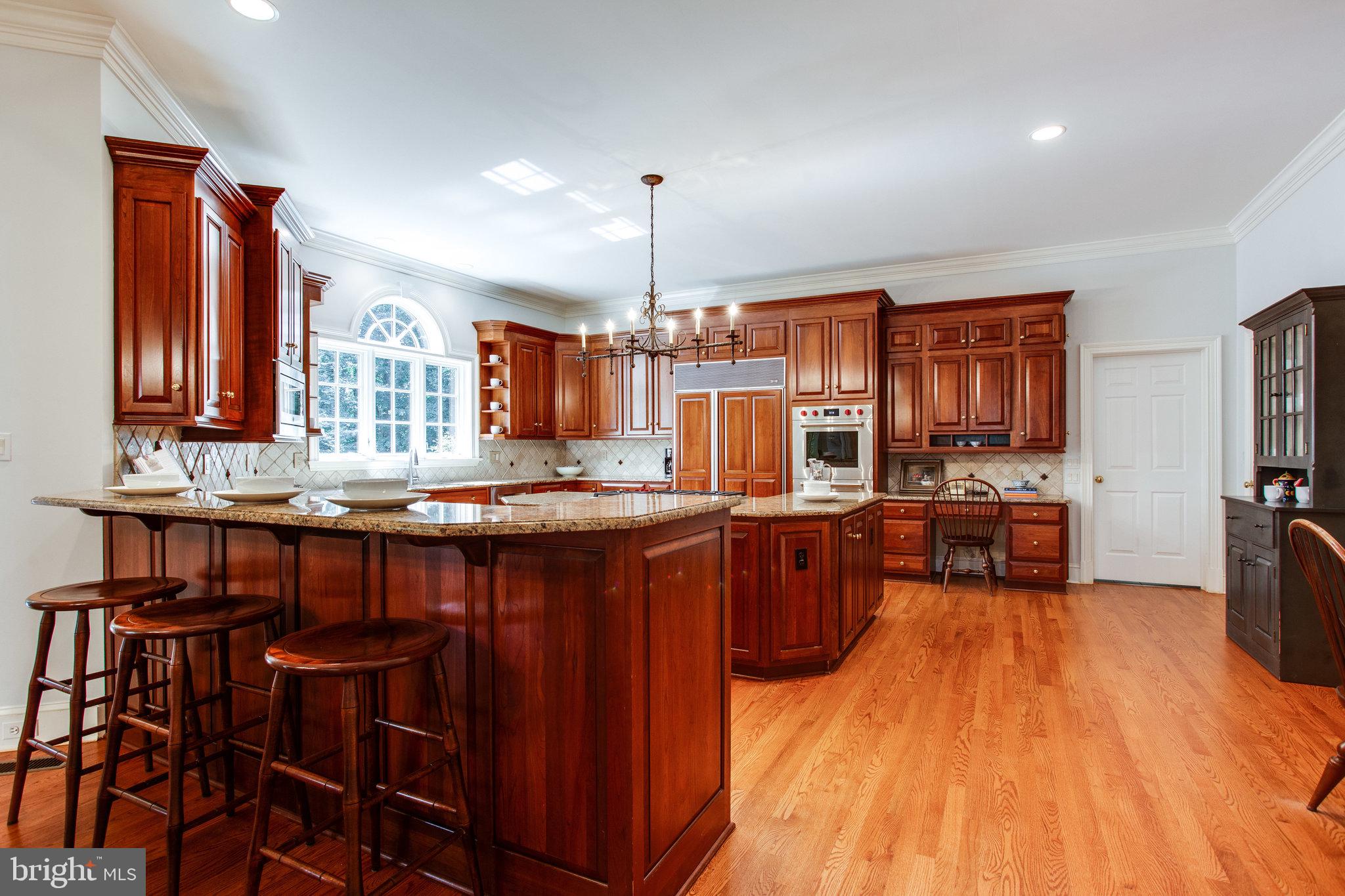 1008 Pine Hill Road McLean, VA 22101 - Photo 14 of 29 a kitchen with stainless steel appliances wooden floor dining table and chairs