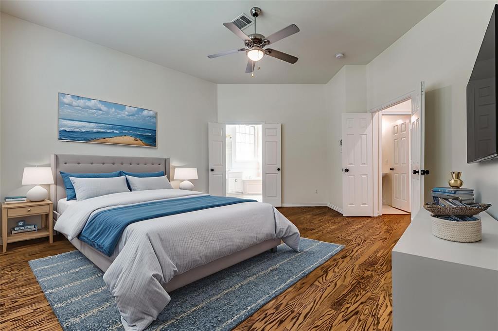 3313 Shady Valley Road Plano, TX 75025 - Photo 11 of 34 a bedroom with bed and a chandelier