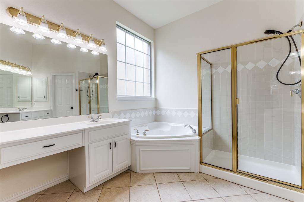 3313 Shady Valley Road Plano, TX 75025 - Photo 13 of 34 a bathroom with a double vanity sink a mirror and a bathtub