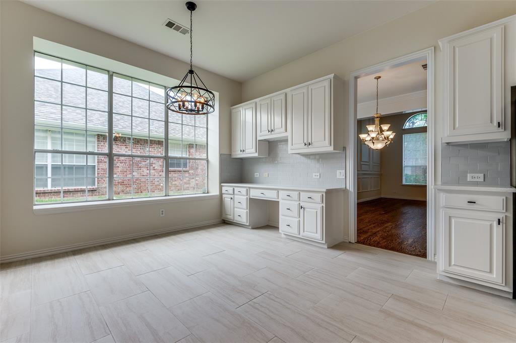 3313 Shady Valley Road Plano, TX 75025 - Photo 18 of 34 a view of a kitchen with granite countertop cabinets and a wooden floor