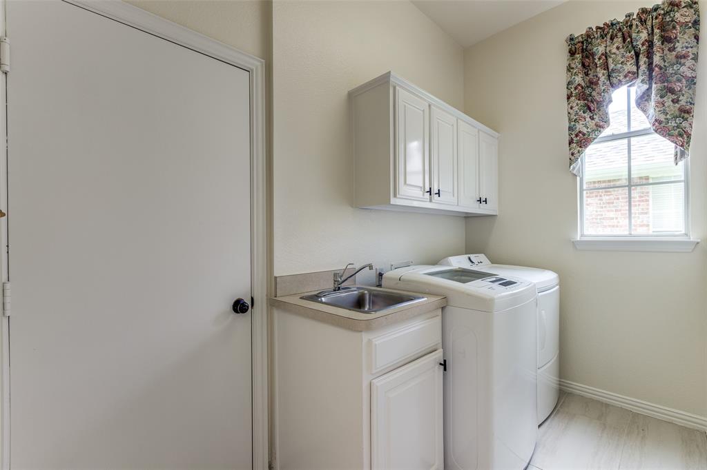 3313 Shady Valley Road Plano, TX 75025 - Photo 19 of 34 a room that has a window in it and white cabinets