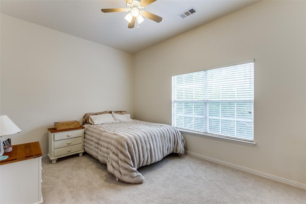 3313 Shady Valley Road Plano, TX 75025 - Photo 23 of 34 a bed sitting in a room next to a window