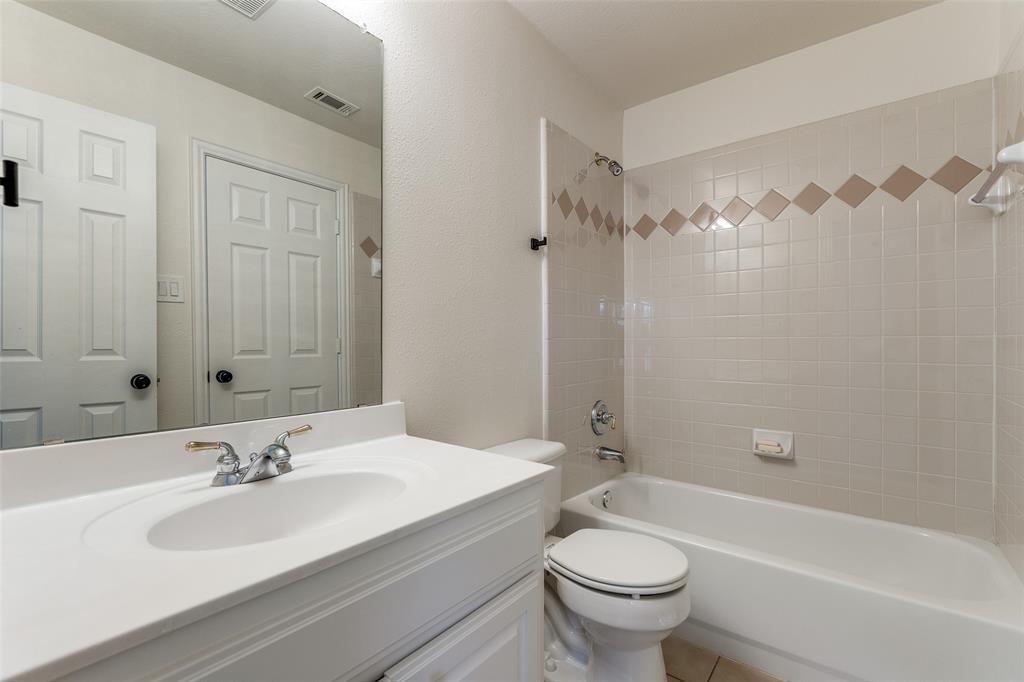 3313 Shady Valley Road Plano, TX 75025 - Photo 26 of 34 a bathroom with a bathtub shower sink mirror and toilet
