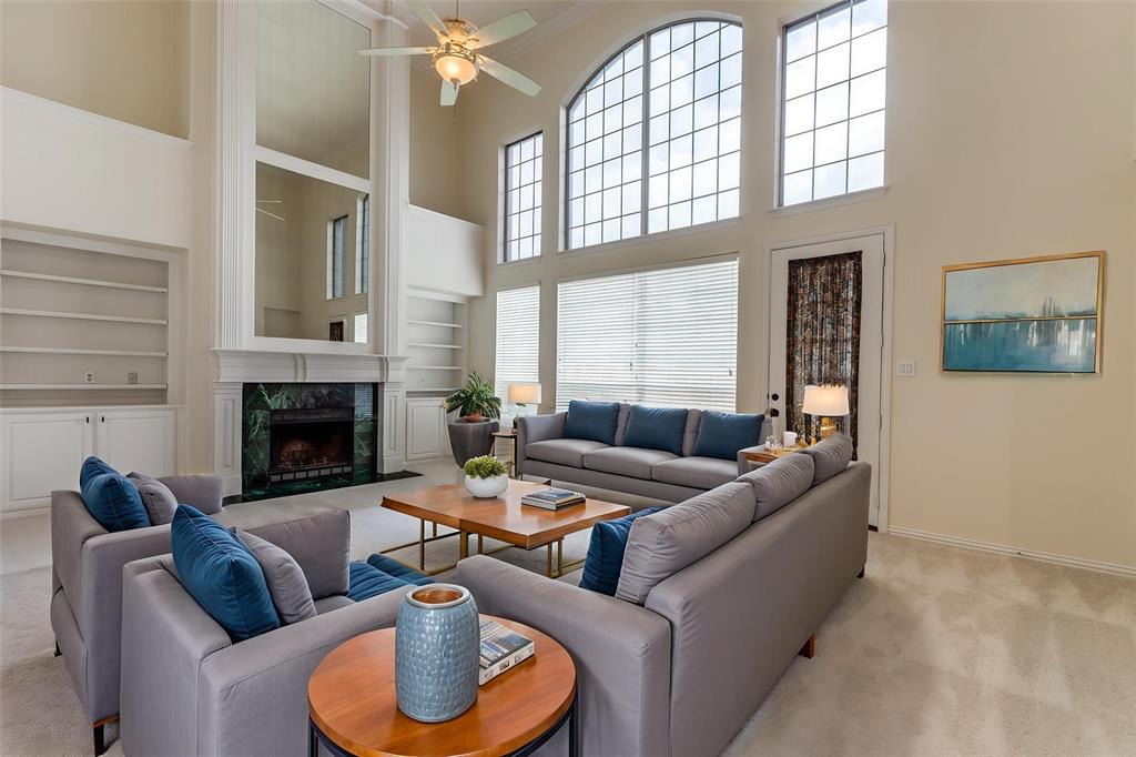 3313 Shady Valley Road Plano, TX 75025 - Photo 9 of 34 a living room with furniture a fireplace and a large window