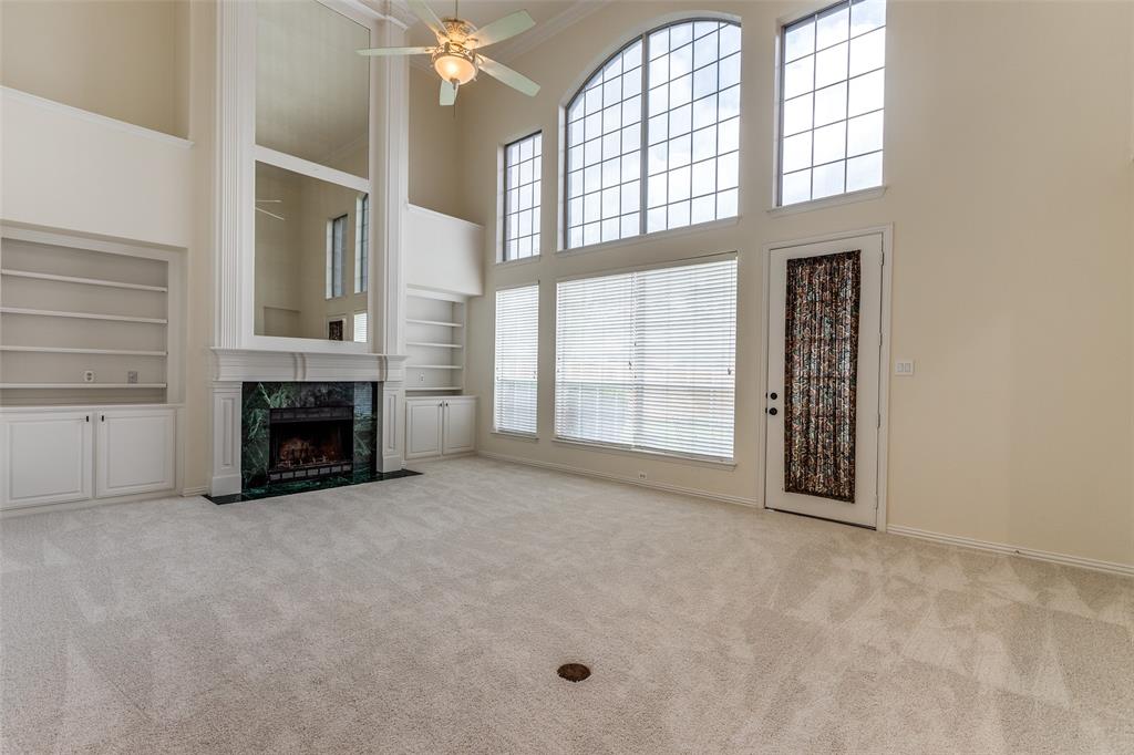 3313 Shady Valley Road Plano, TX 75025 - Photo 10 of 34 an empty room with windows fireplace and fans