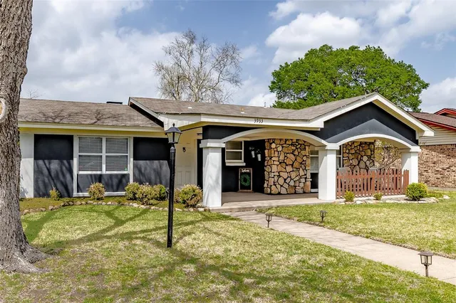 a view of a house with large windows and a yard