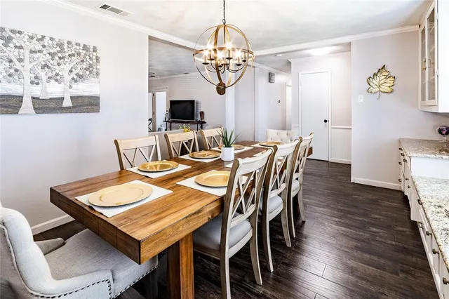 a view of a dining room with furniture and chandelier