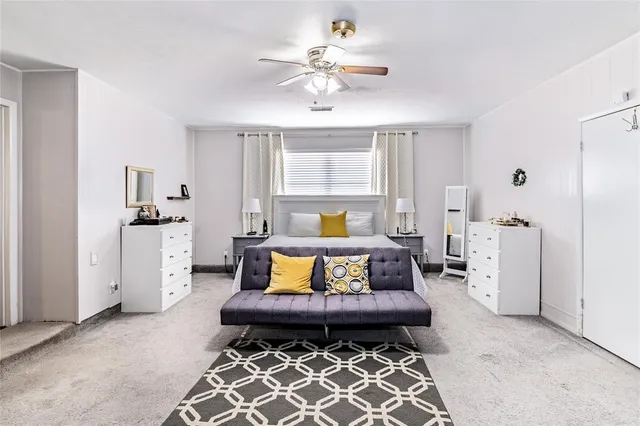 a living room with furniture a window and a chandelier
