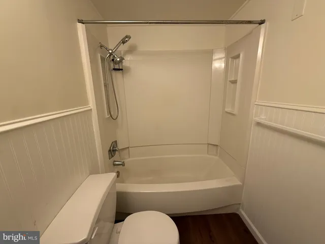 a bathroom with a shower a toilet and a shower
