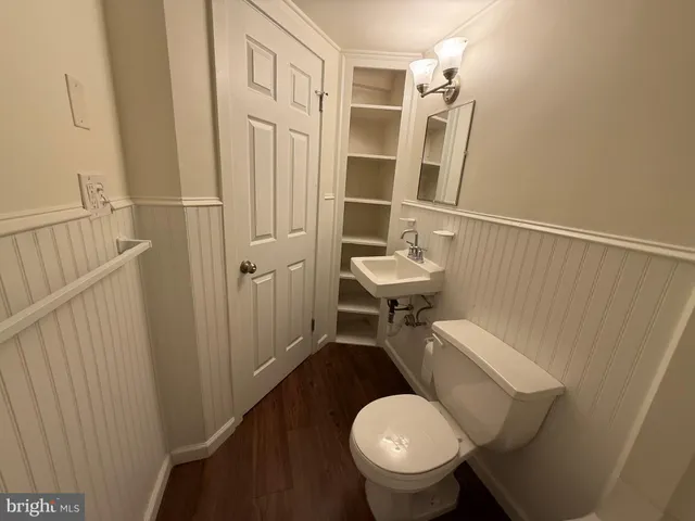a bathroom with a sink a toilet a mirror and shower
