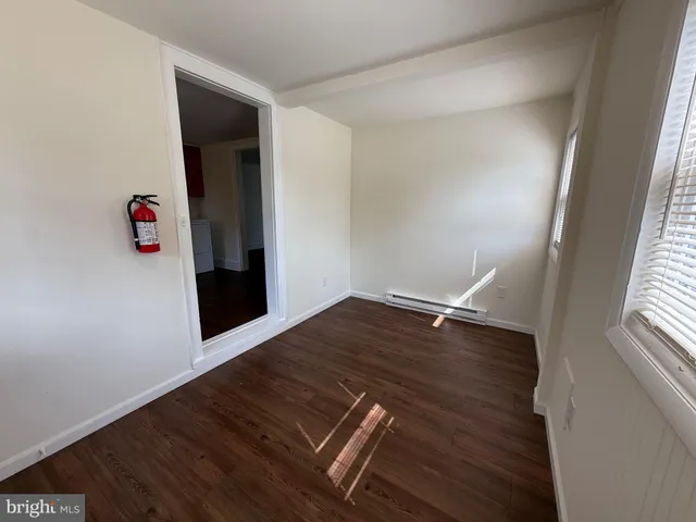 a view of wooden floor and windows in a room